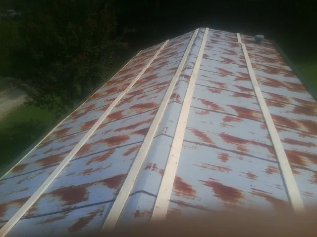 Rusted metal roof panels with new wood purlins before replacement — Storm Damage Roof Repair in Leadore by Roofing Brothers